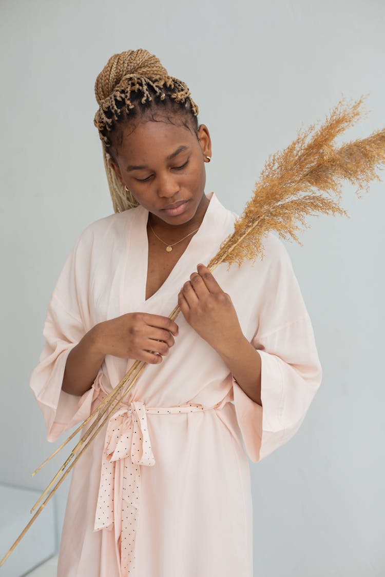 Woman In Pink Robe Holding A