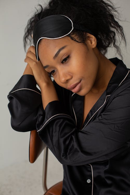 Free Woman Wearing Black Sleepwear Sitting on Chair Stock Photo