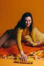 Woman in Yellow Long Sleeve Shirt Playing With A Toy Car