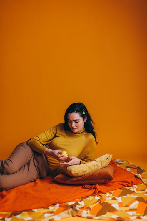 Free Woman Lying In An Orange Linen Stock Photo