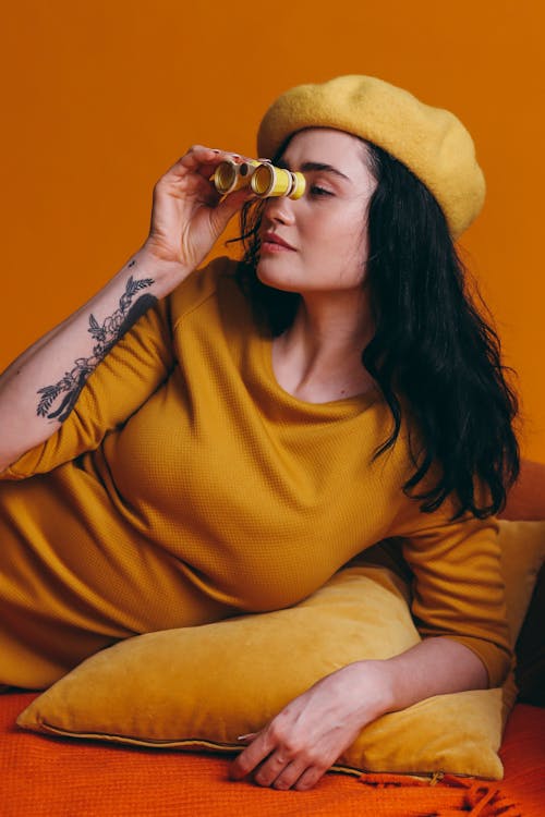 Free Woman In Yellow Outfit Holding A Yellow Binoculars Stock Photo