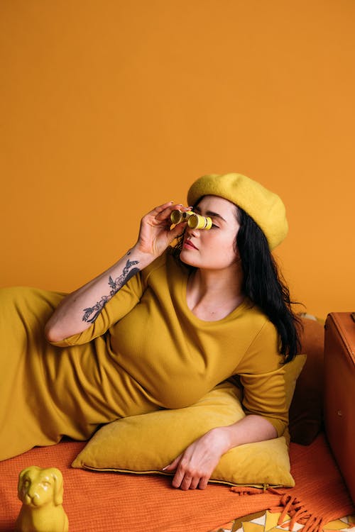 Free Woman Holding A Yellow Binoculars Stock Photo