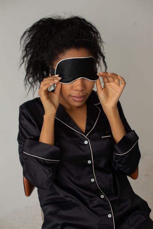 A Woman Wearing a Pajama and a Sleep Mask