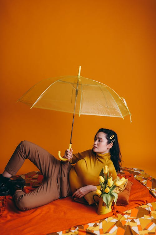 Woman in Brown Long Sleeve Shirt Holding Umbrella