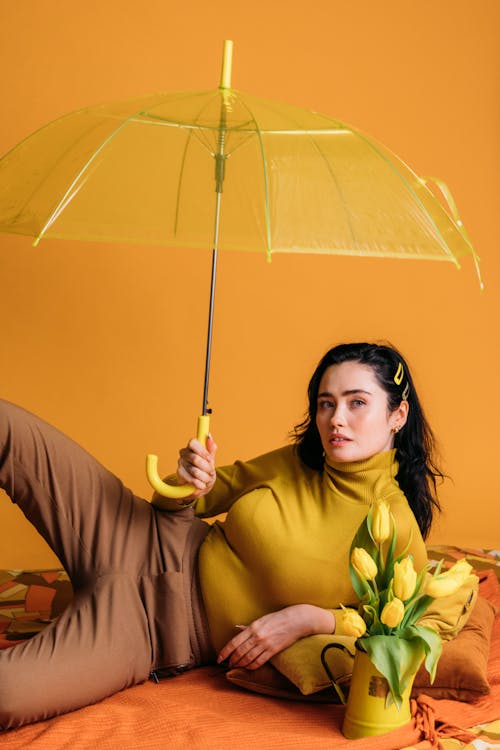 Woman in Yellow Long Sleeve Shirt Holding Umbrella