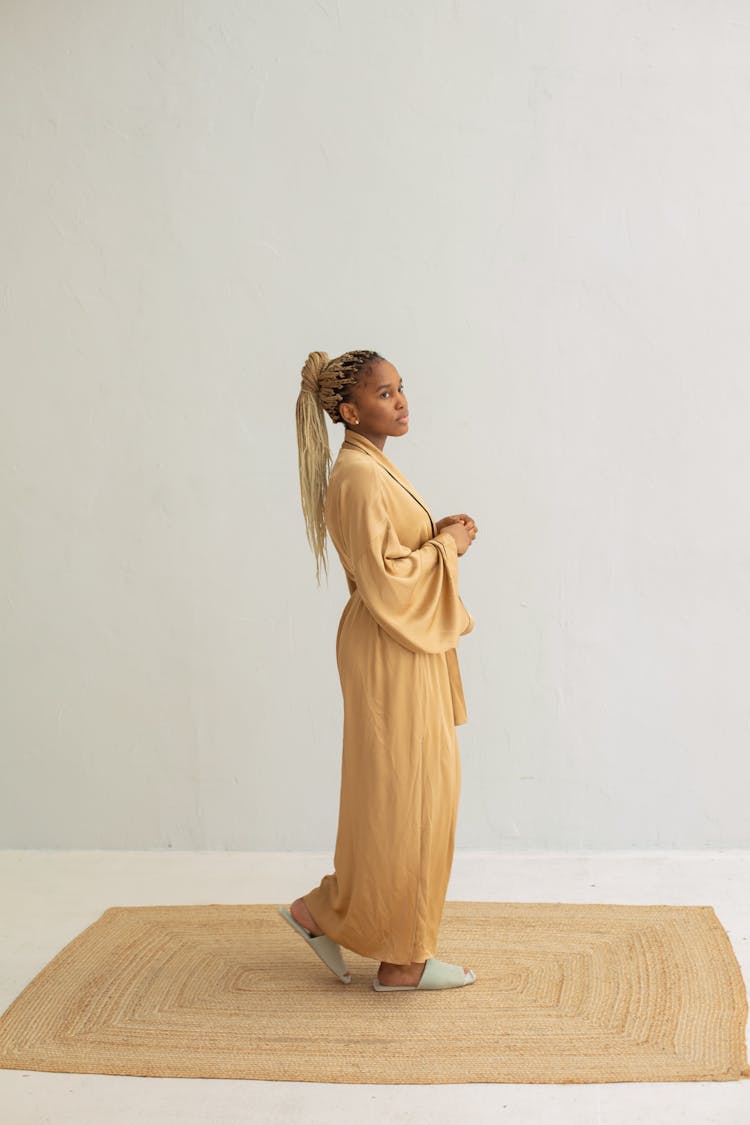 Woman In Silk Bathrobe In White Studio Background