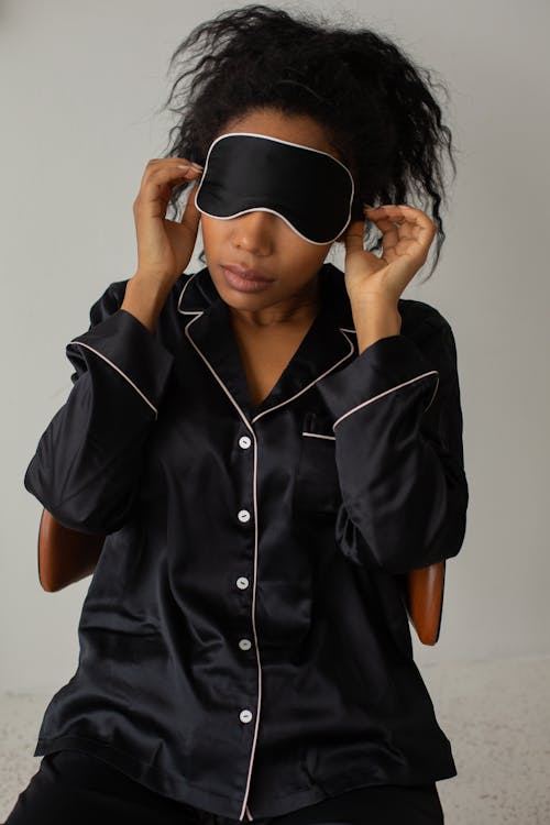 Free Woman in Black and White Long Sleeves Top Wearing Black Sleep Mask Stock Photo
