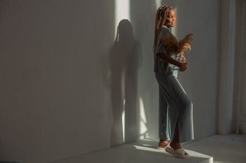 Free Smiling Woman in Home Wear Posing in Studio Stock Photo