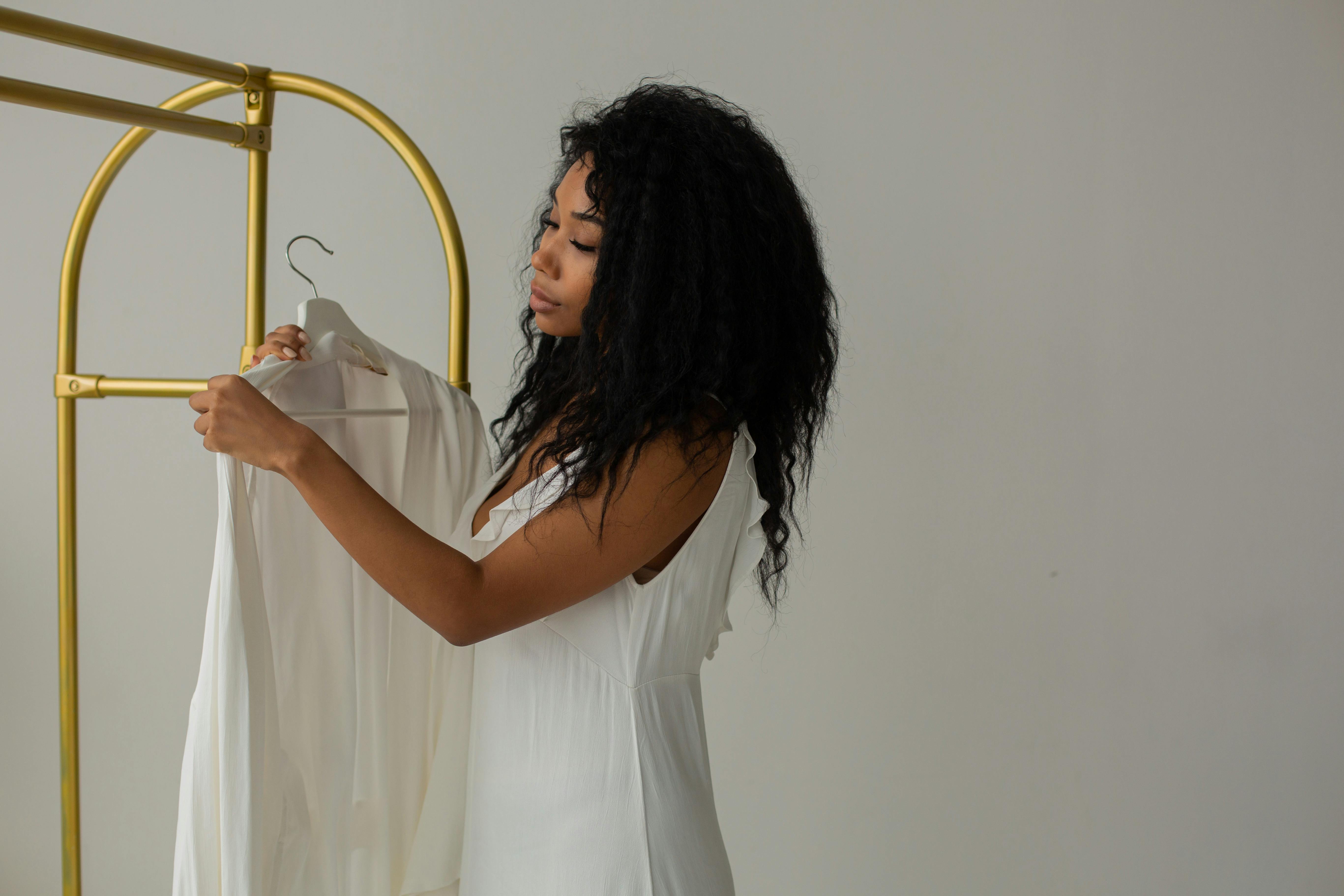 a woman holding a robe in hanger