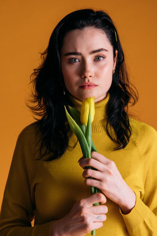 Woman Holding A Yellow Flower