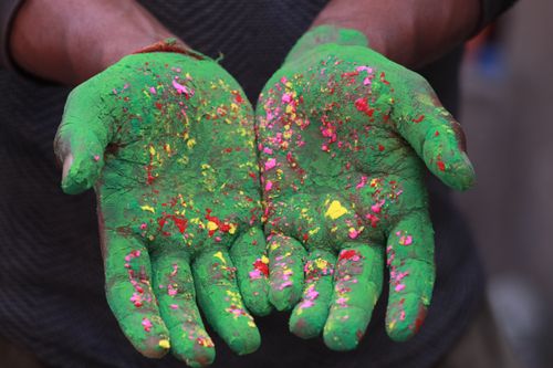 Free Close-up of hands covered in colorful Holi powder during the celebration in Patna, India. Stock Photo