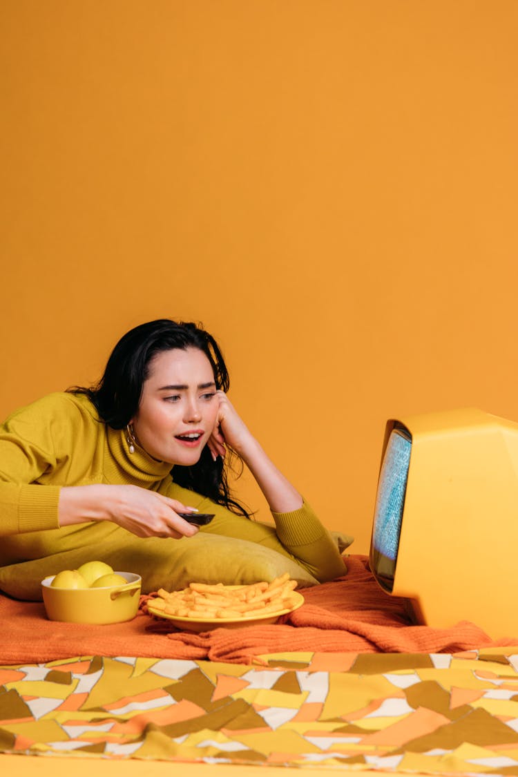 Woman Waching TV With Food