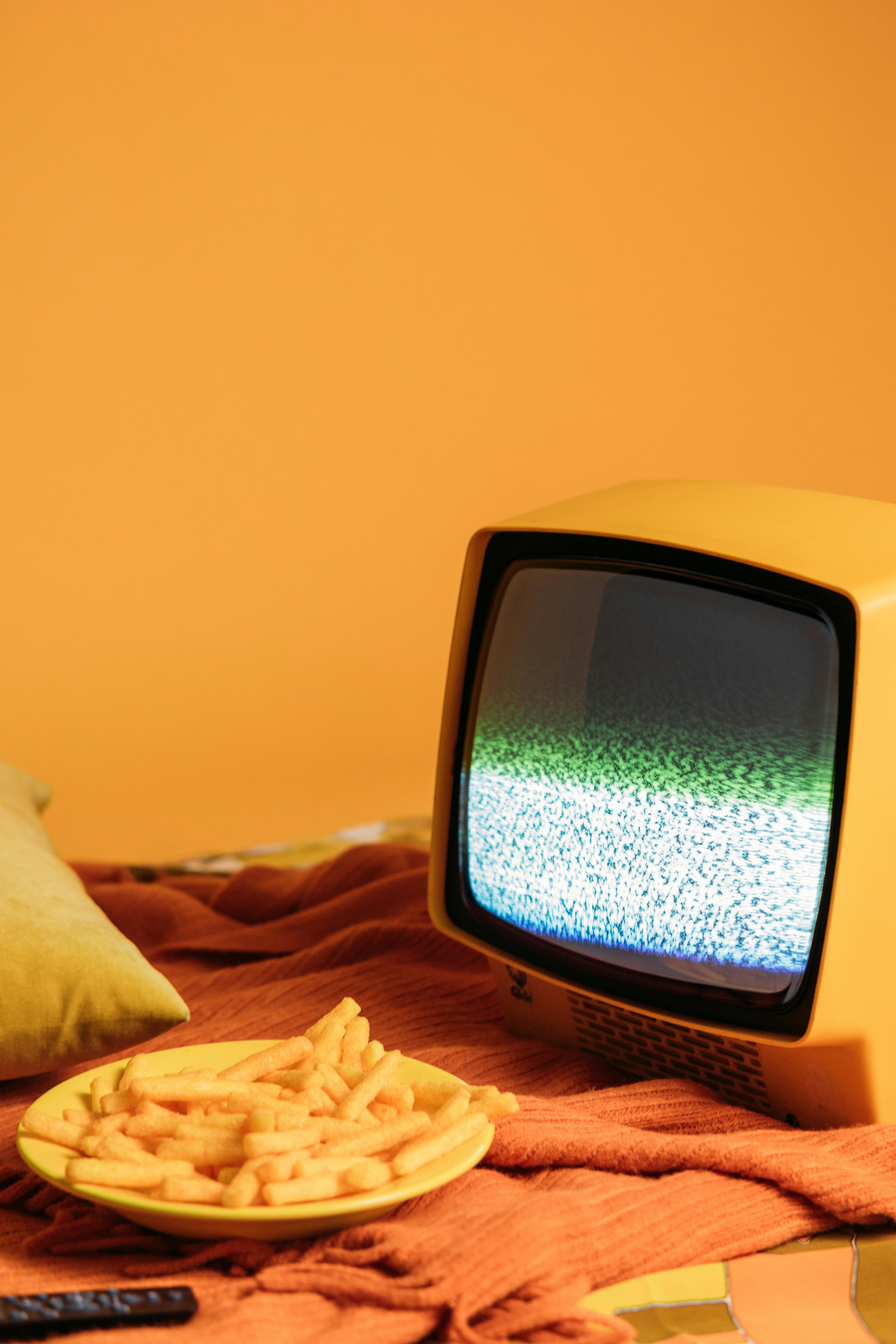 yellow vintage television with blank screen