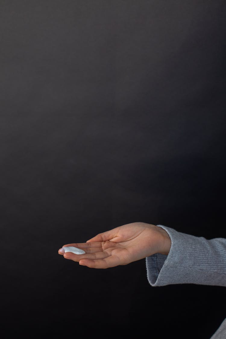 Woman With Smear Of Cream On Hand