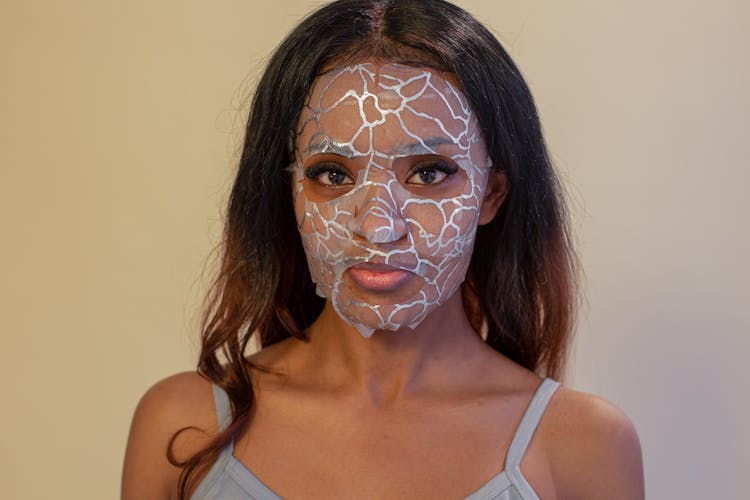 Black Woman With Hydrogel Mask On Light Background