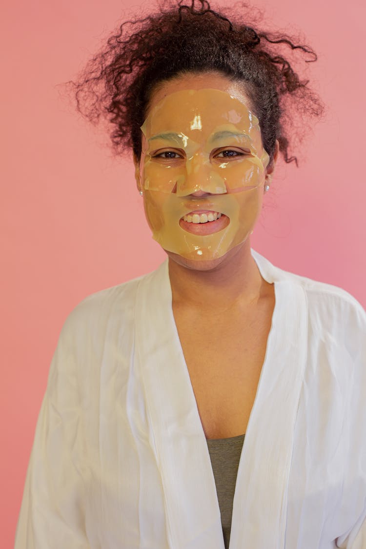 Smiling Ethnic Woman With Hydrogel Mask On Face