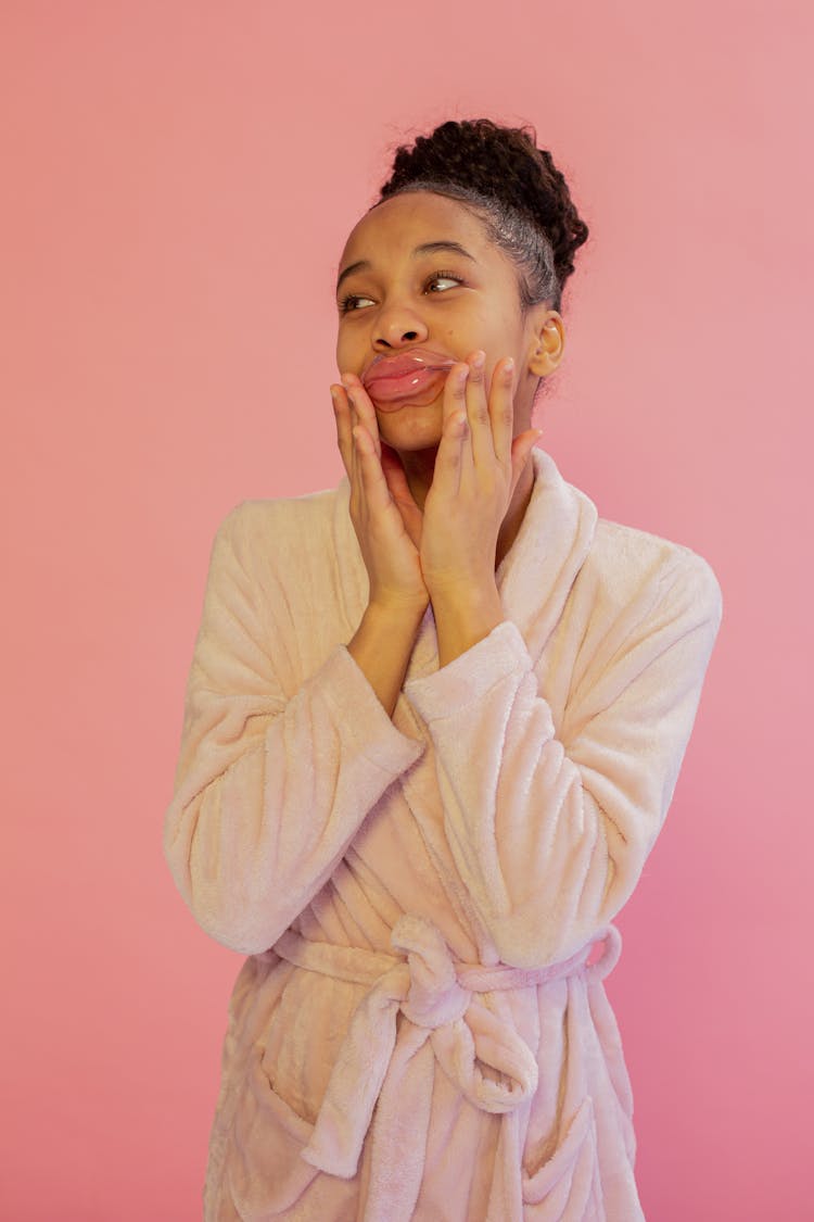 Smiling Black Teen With Lip Mask On Pink Background