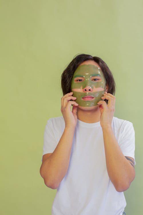 Asian man with facial mask during skincare treatment