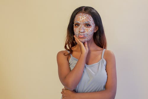 Black woman with facial mask in studio