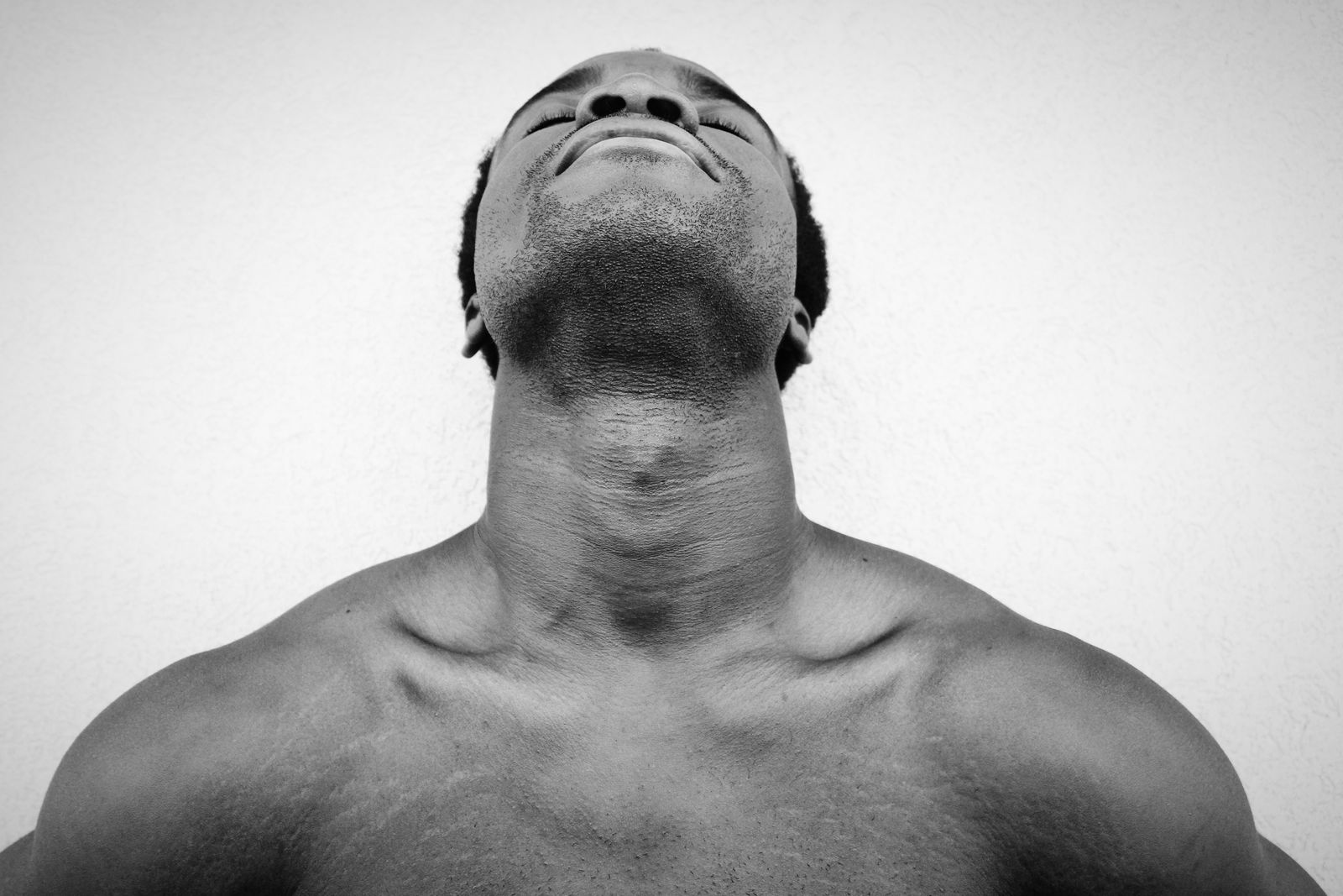 Bright clinic room scene focused on neck and upper back positioning