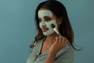 Woman Putting on Facial Cream with a Brush