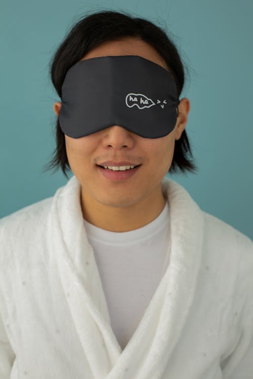 Free Woman in White Bathrobe Wearing a Eye Mask Stock Photo