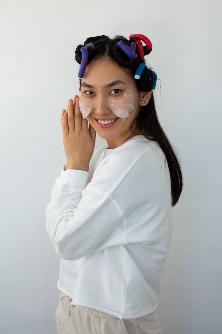 Woman With Under Eye Patch Doing A Sleeping Gesture