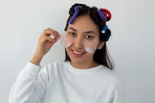 Free Woman Putting on Eye Mask Stock Photo