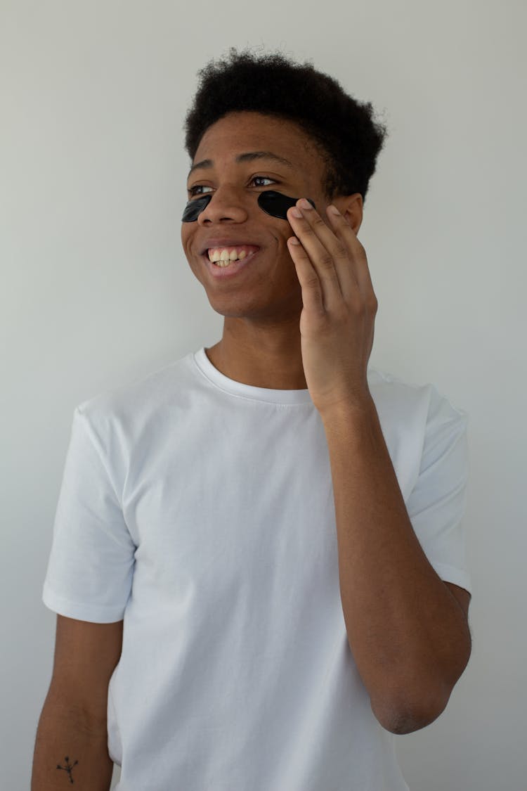 Smiling Black Teen With Eye Patches On Face