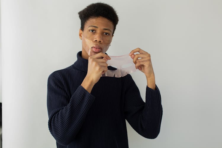 Black Man With Sheet Masks On Light Background