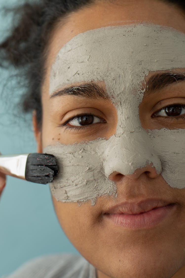 Black Woman Applying Clay Mask