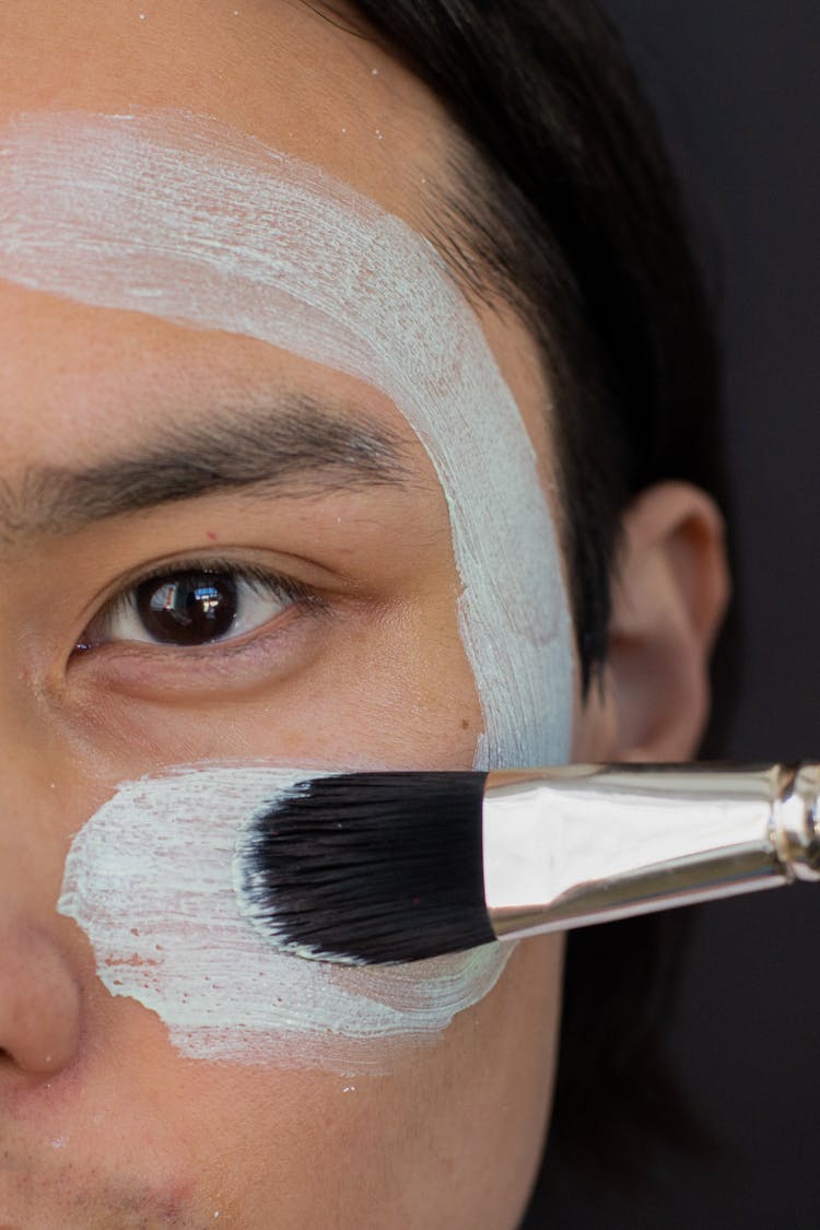 Anonymous Asian Man Applying Clay Mask