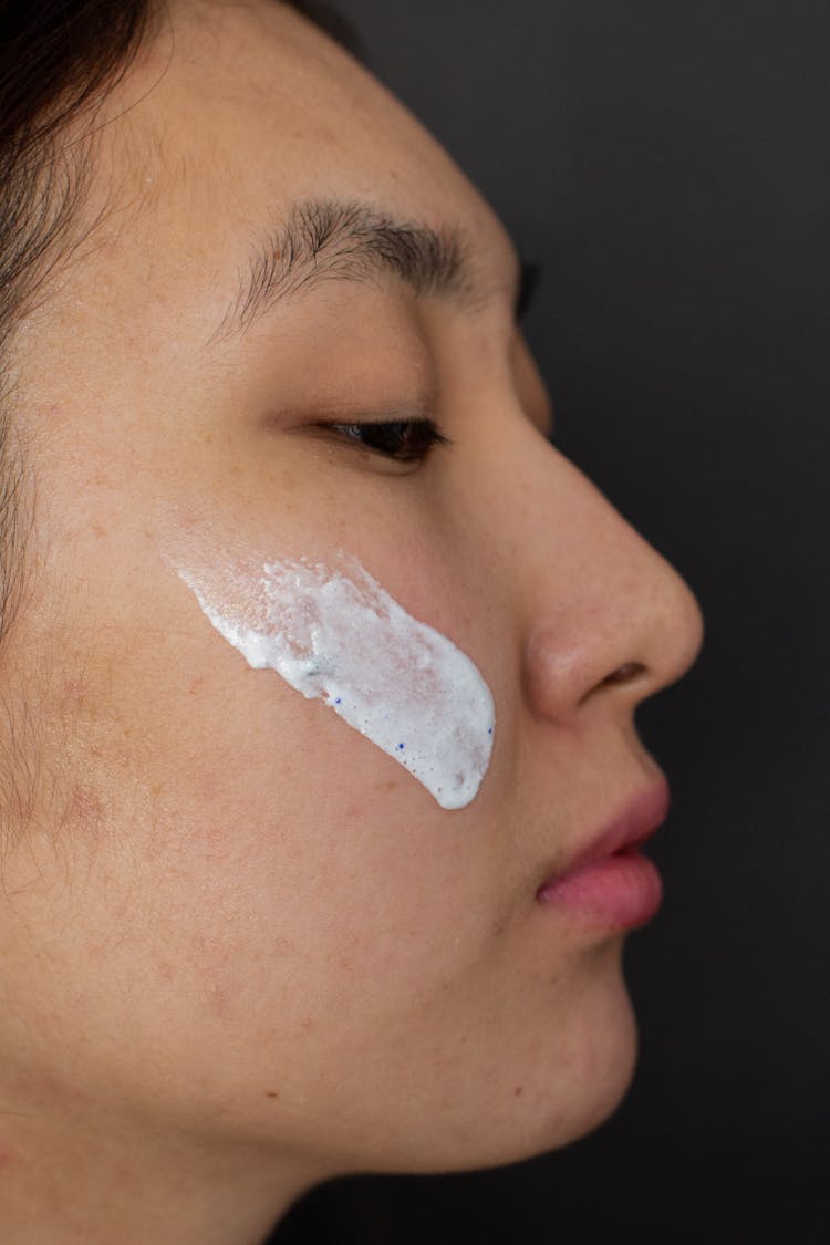 Asian Man With Clay Mask On Cheek