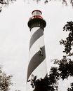 White and Black Concrete Lighthouse Under White Clouds