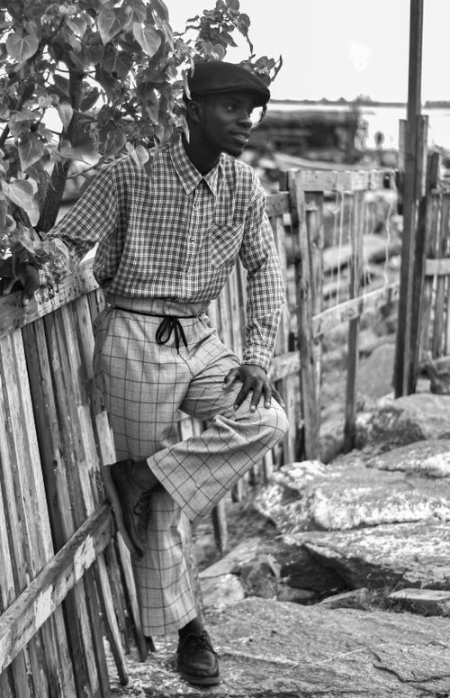 Free Black and white portrait of a stylish man in a rural village setting in Takoradi, Ghana. Stock Photo