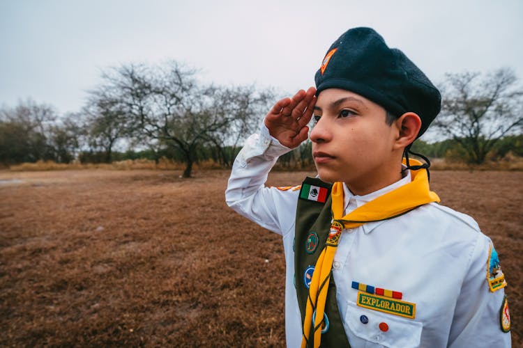 Boy In Scout Uniform Saluting