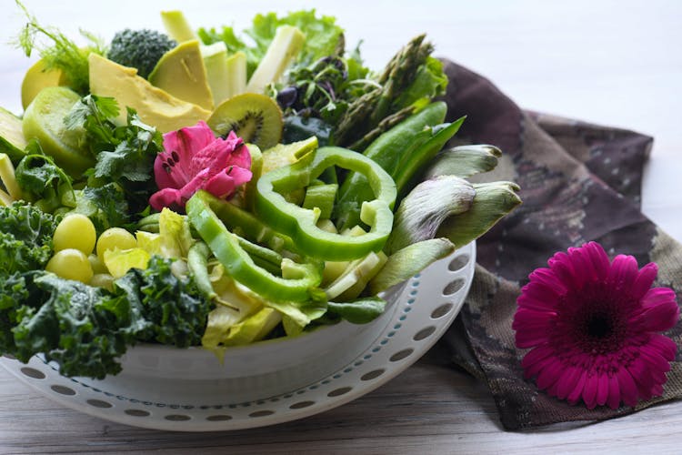 Close-up Of Green Fresh Vegetables And Fruits In Plate