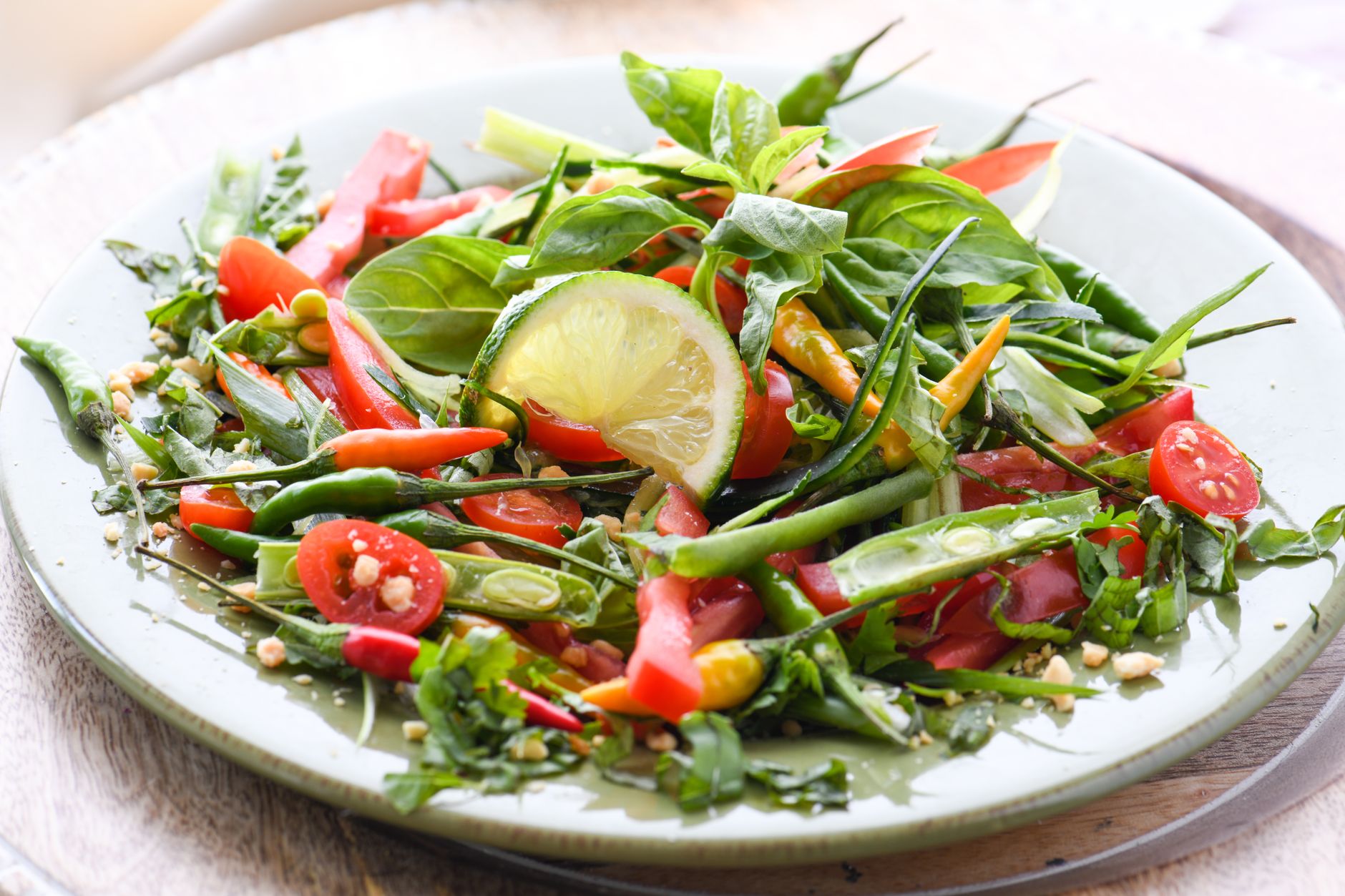 Close-up of roasted green beans and cherry tomatoes in a serving bowl