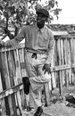 Man in Dress Shirt and Pants Standing Beside Wooden Fence