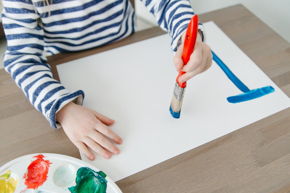 A Person Painting on a White Paper