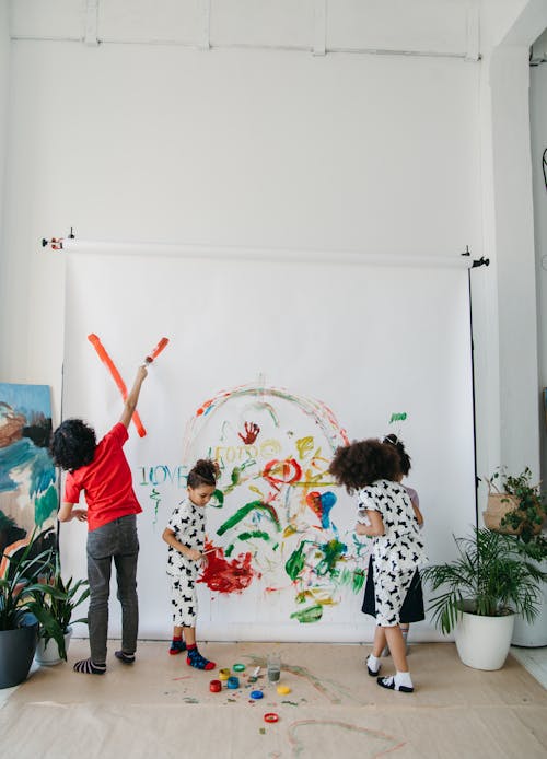 Kids Painting on a White Wall