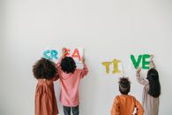 Kids Posting the Artwork on a White Wall