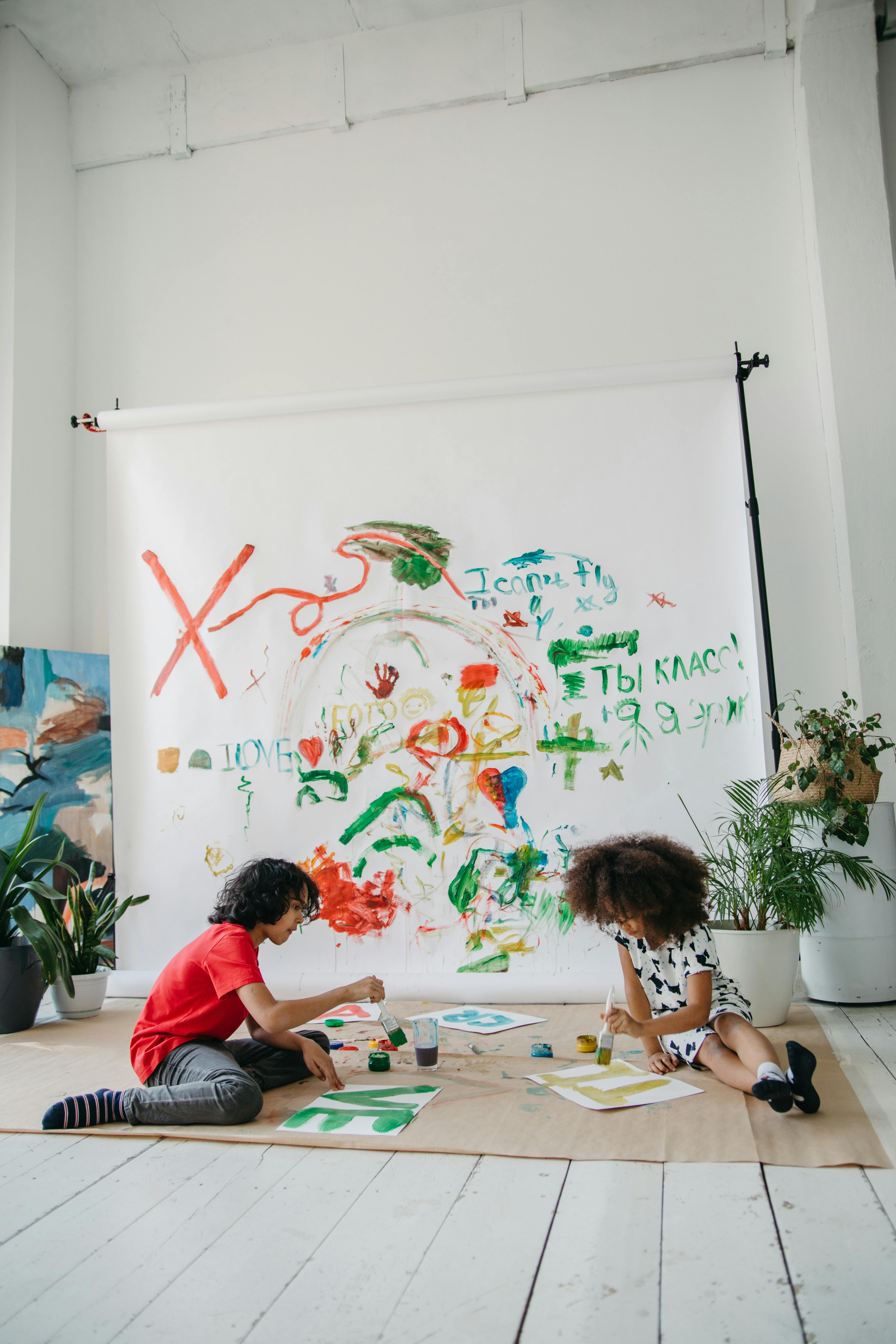 Little Kids Painting Design on a White Wall · Free Stock Photo