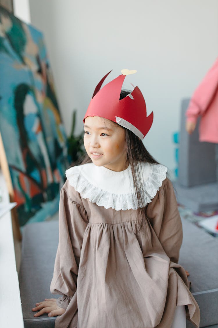 A Girl Wearing A Red Crown Paper Cutout