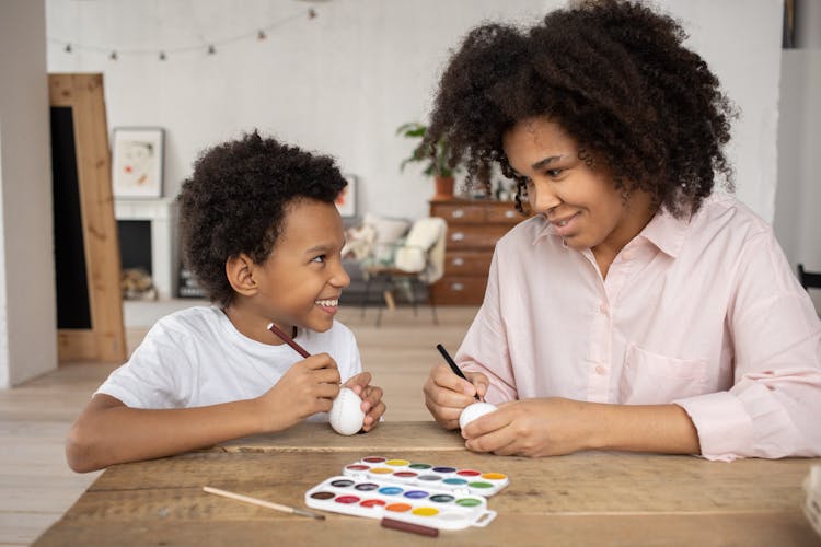 Smiling Mother And Son Painting Easter Eggs