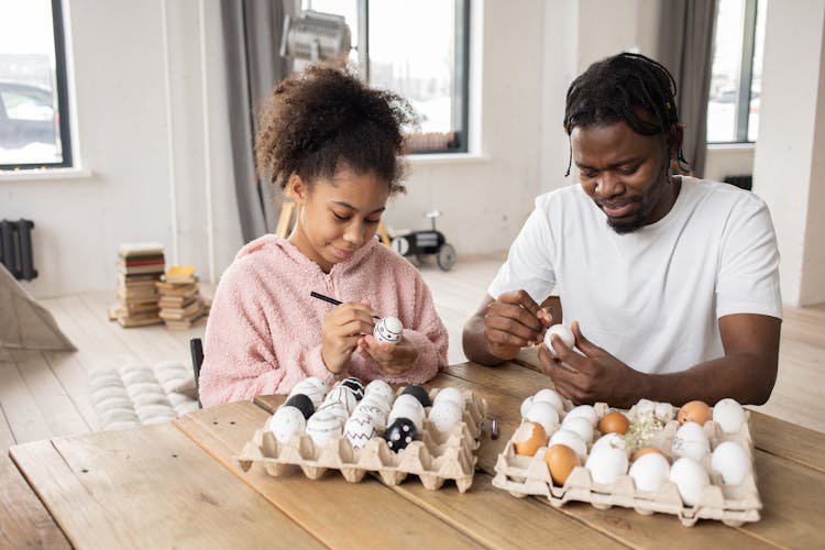 Woman And Man Painting Easter Eggs