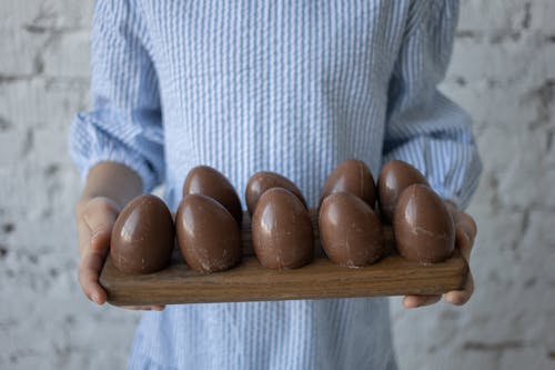 Person Holding Tray of Chocolate Eggs