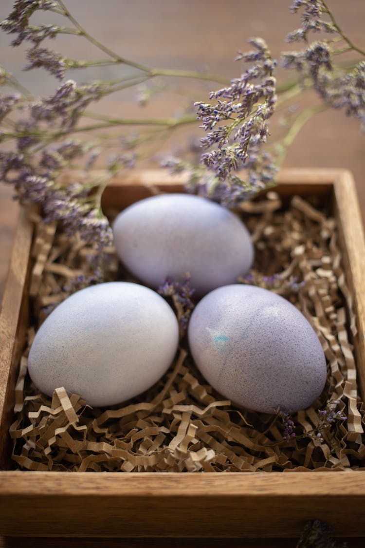 Purple Eggs Lying In Wooden Box