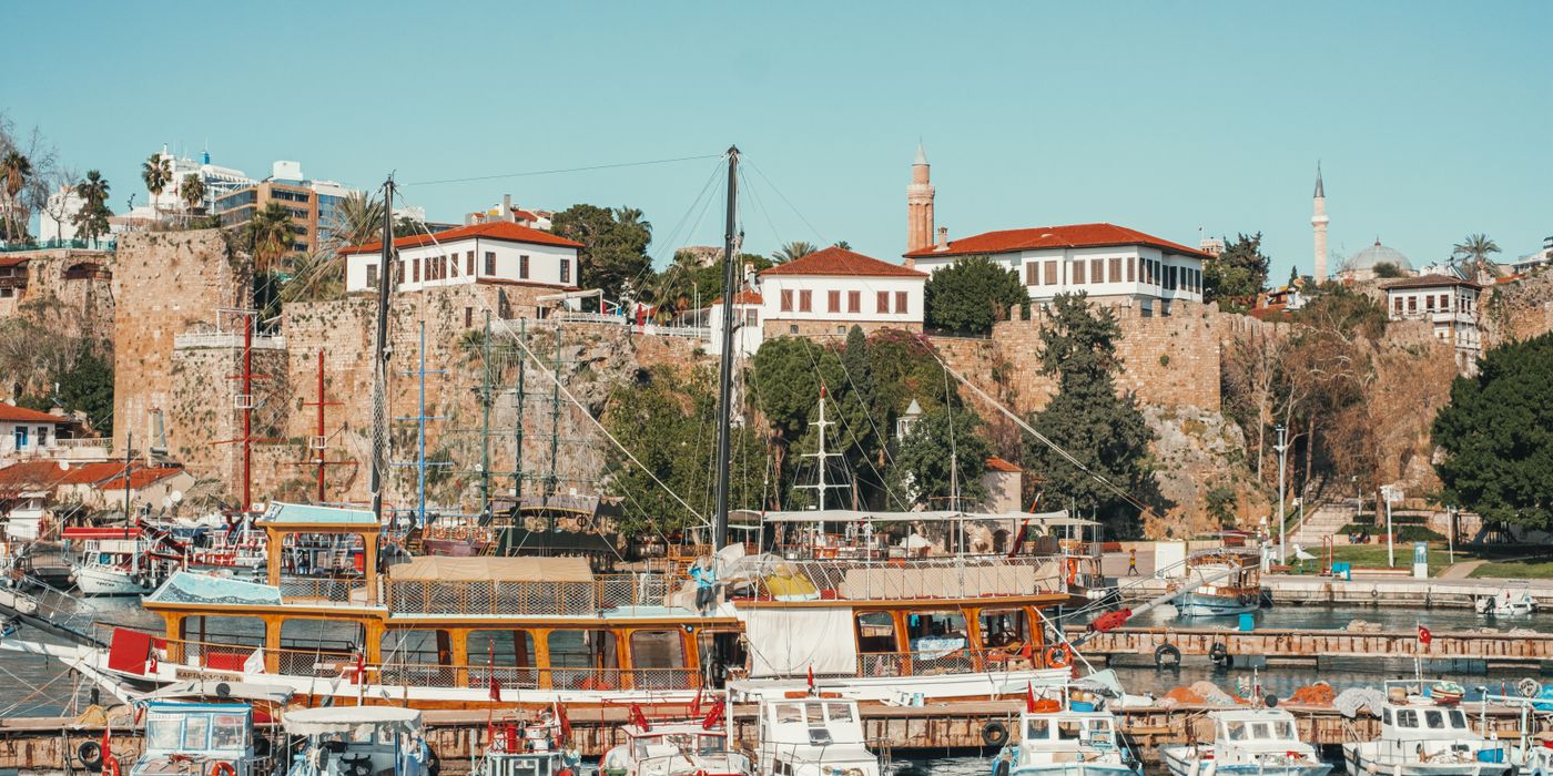 Antalya old town street with Ottoman houses and Mediterranean sea beyond