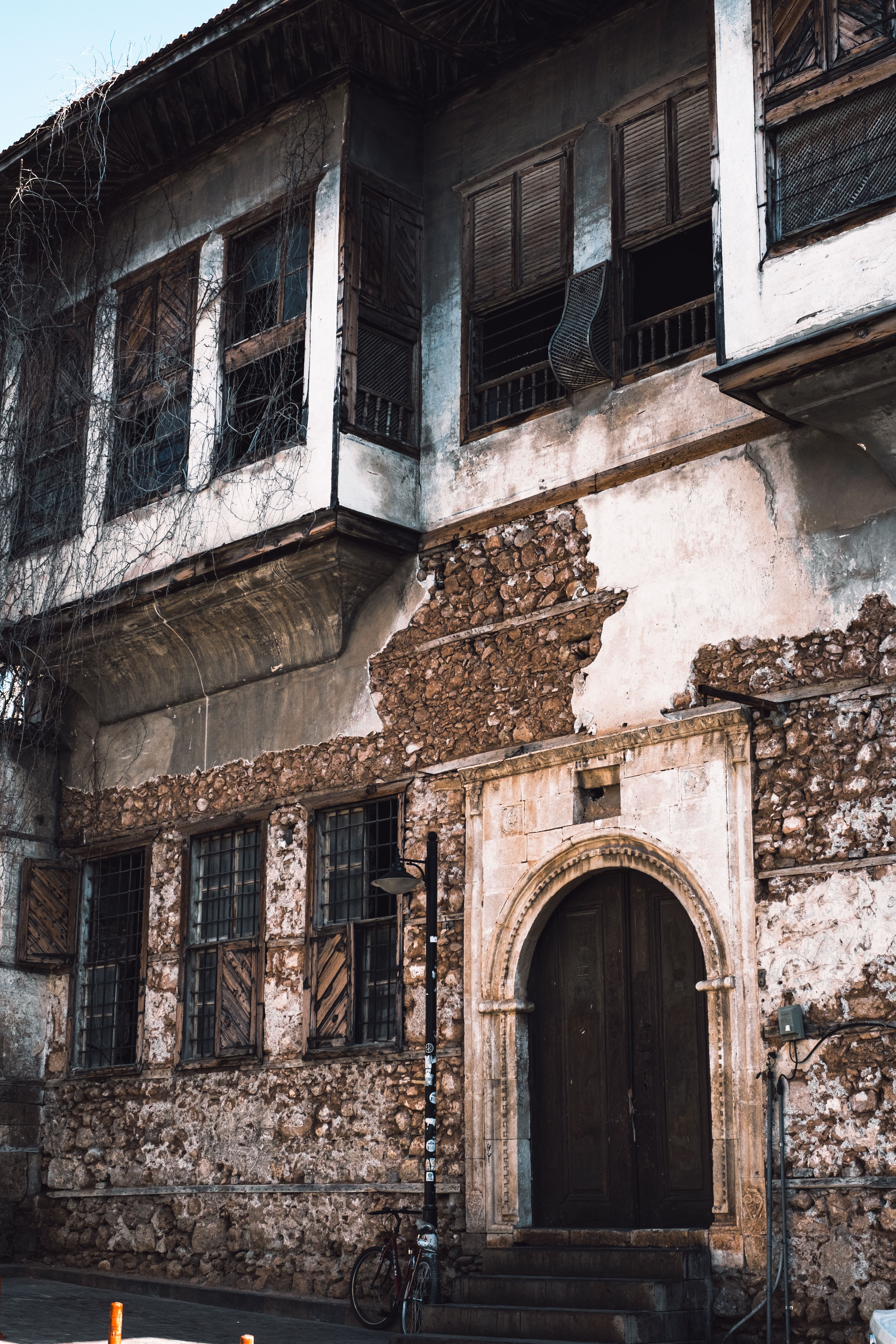 A Ruined Cobblestone Building with Arched Door · Free Stock Photo